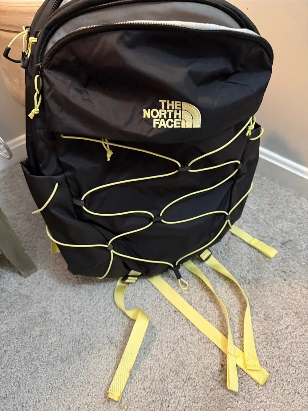 The North Face Black Backpack with Yellow Bungee and Straps